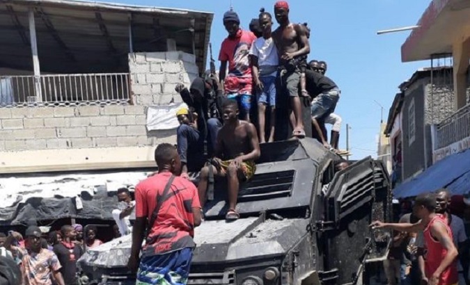 Gang members capture a Haitian police armored car, 2023.