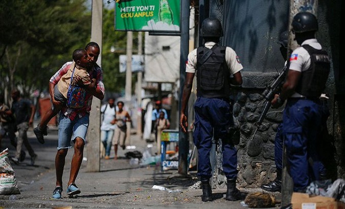 A father carries his son amid a police operation against gangs in Port-au-Prince, Haiti, March 3, 2023.