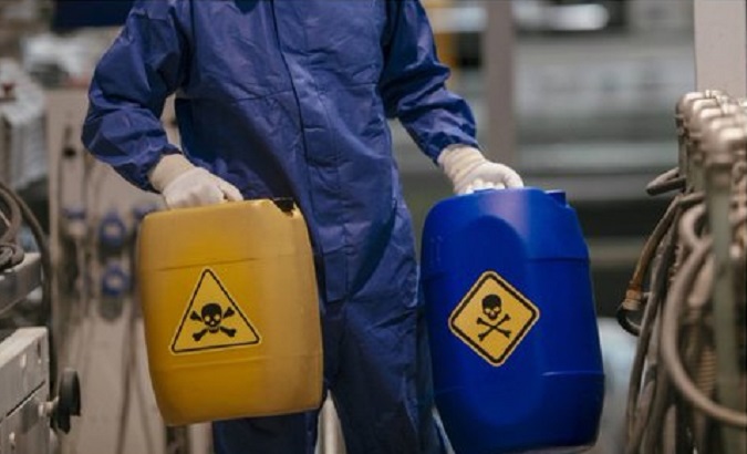 A worker loading hazardous chemicals into a biolab.