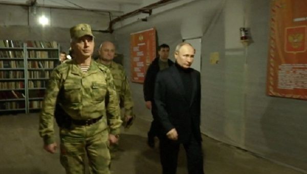 Russian President Vladimir Putin (R) visits a military headquarters in Luhansk, April 18, 2023. 