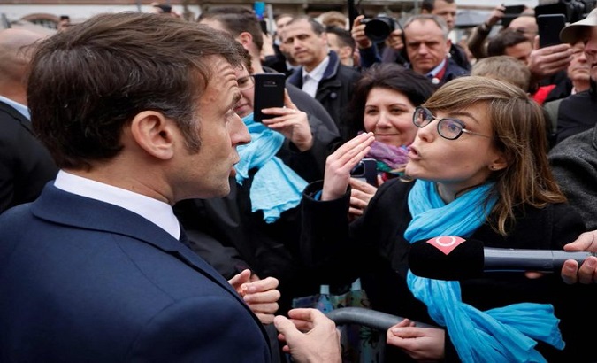 French President Emmanuel Macron (L) meets citizens in Selestat commune, April 19, 2023.