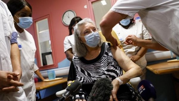 A French woman receives a dose of COVID-19 vaccine.