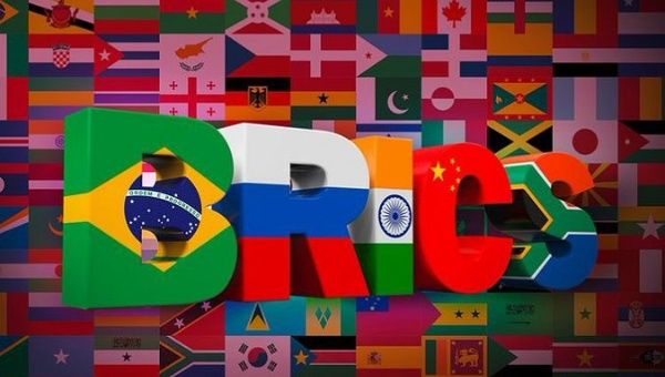 Flags of the countries against the background of the acronym BRICS.