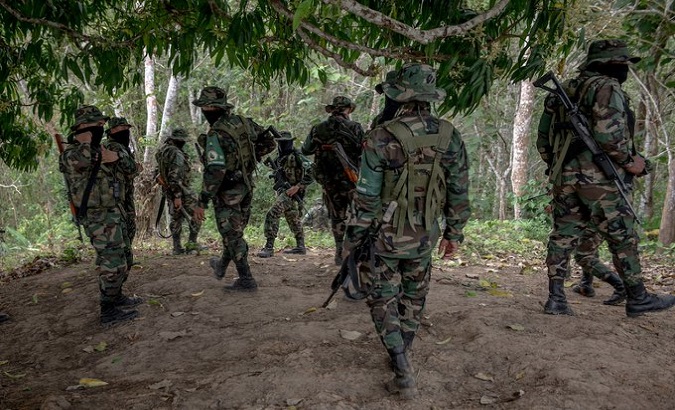An unit of the Gulf Clan moves through the forest in Antioquia, Colombia.