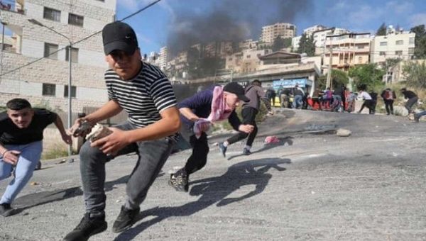 Palestinians flee from Israeli occupation forces attacks in Nablus, May 9, 2023.