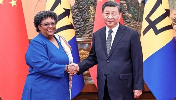 Barbadian PM Mia Amor Mottley (L) & Chinese President Xi Jinping (R), June 27, 2023.