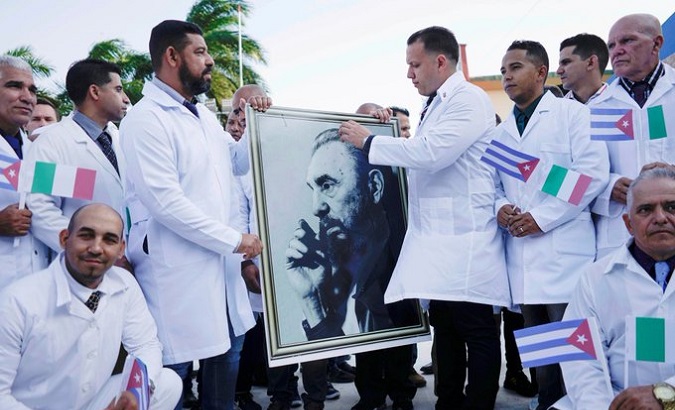 A photo of Fidel Castro held by Cuban doctors upon his arrival in Italy.