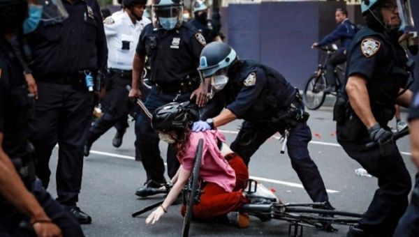 Police officers attack a citizen who protests against racial injustice in New York, U.S., 2020.