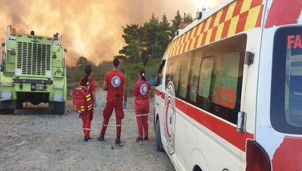 Syrian Red Crescent ambulance personnel helping on the battle against Syria wildfires. Jul. 27, 2023.