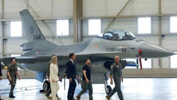Ukrainian President Volodymyr Zelensky walk past an F-16, Eindhoven, Netherlands.
