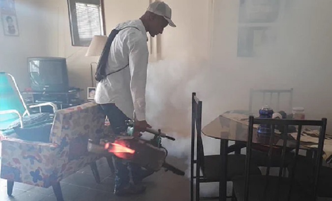 Health worker fumigates a house, Cuba, Sept. 2023.