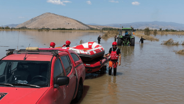 A vehicle of the Fire Brigade tows two boats in Palamas village, Greece, Sept. 10, 2023.