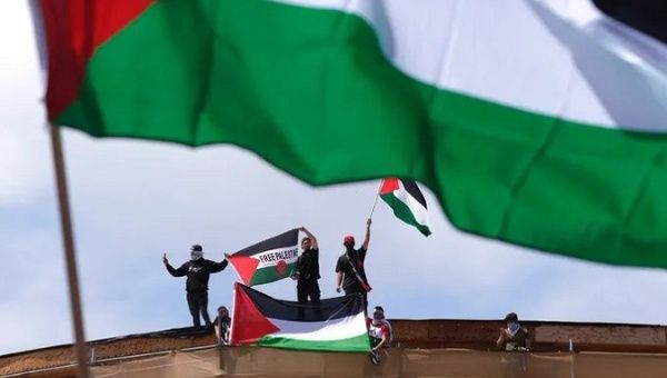 People holding Palestinian flags.
