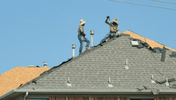 Workers repair a roof during a heat wave in Plano, Texas, U.S., 2023.