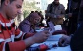 Palestinians update their voting details at the Election Commission.