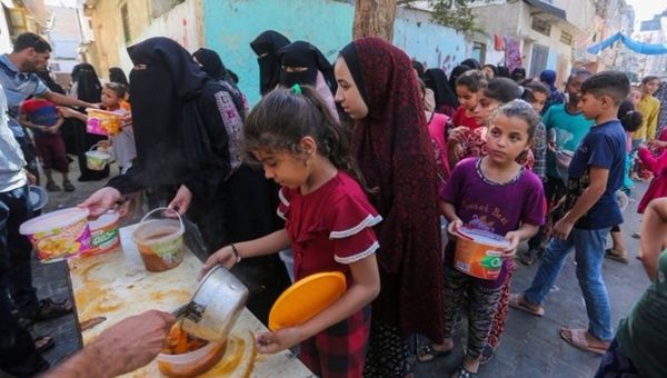 People displaced by Israeli bombing line up to receive food, Nov. 12, 2023.