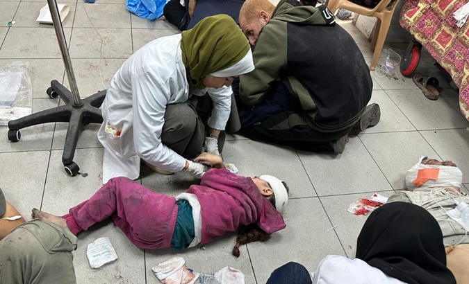 A doctor treats Palestinian patients at Kamal Adwan Hospital, Gaza, Dec. 4, 2023.