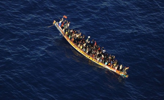 Migrants on a boat in precarious conditions adrift in international waters.