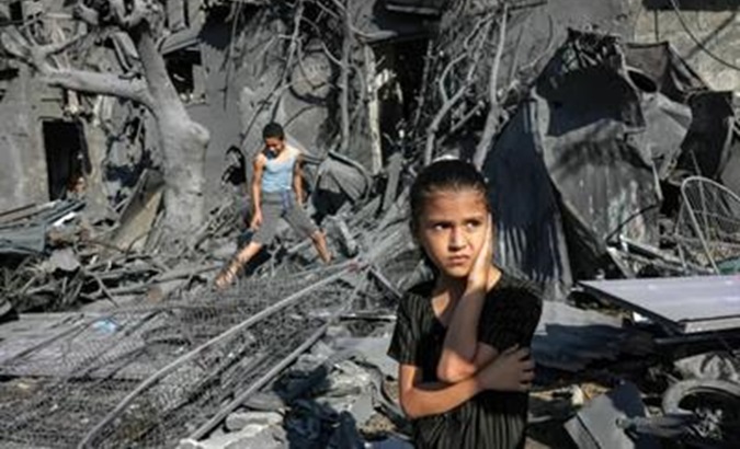Palestinian children wander through the rubble caused by Israeli bombings, Jan. 2024.