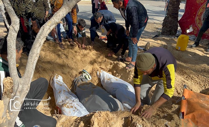 Bodies being buried in the Nasser Hospital's courtyards, Khan Yunis, Gaza.