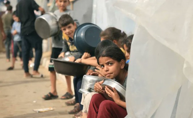 Palestinian children wait for food aid in Gaza, Feb. 19, 2024.