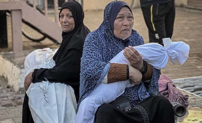 Palestinian women carry the bodies of loved ones killed by Israeli bombings, 2024.