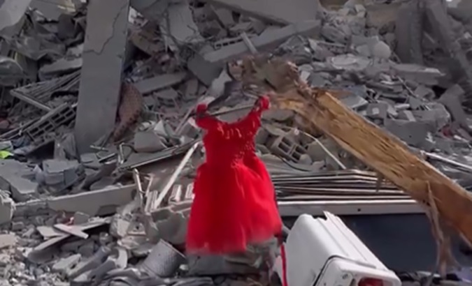 A girl's dress is left hanging amid the rubble caused by Israeli bombings in Gaza, March 17, 2024.