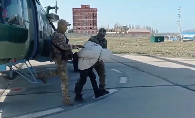 Russian security forces transport suspect, April 4, 2024.