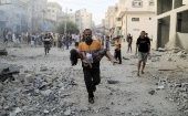 Gazan families flee Israeli bombings, 2024.