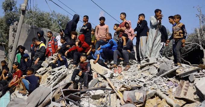 Palestinians on rubble of the destroyed city, April 10, 2024