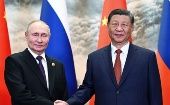 Presidents Vladimir Putin (L) and Xi Jinping (R).