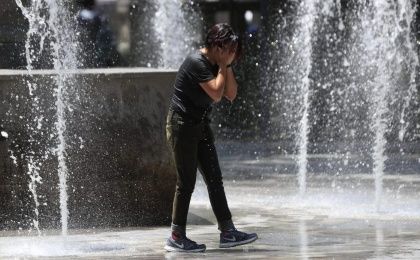 A man refreshing in a public fountaine in Mexico.
