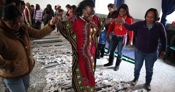 Maria Eugenia Urrutia, head of the Association of Afro-Colombian women for Peace (Afromupaz), crosses a symbolic bridge during a therapy session she runs for rape survivors in Bogota, in April 2014.